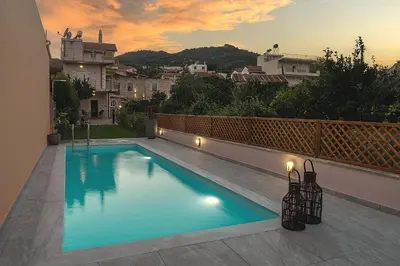 a swimming pool on the roof of a house at Arch Houses - Nature Escape with Shared Pool in Spiliá