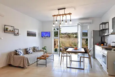 a living room with a couch and a table at Livingfy Apt with mountain view & garden in Vamos