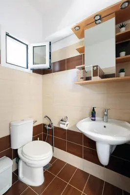 a bathroom with a toilet and a sink at Livingfy Apt with mountain view & garden in Vamos