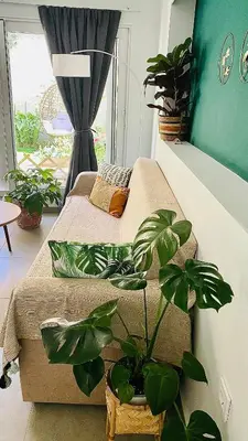 a bedroom with a bed with plants on it at Ivy, 4 minutes from the sea in Chania Town