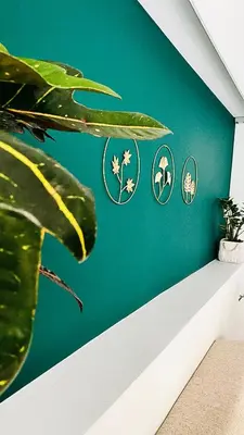 a room with a green wall with four stickers on it at Ivy, 4 minutes from the sea in Chania Town