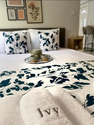 a bed with blue and white sheets and towels on it at Ivy, 4 minutes from the sea in Chania Town
