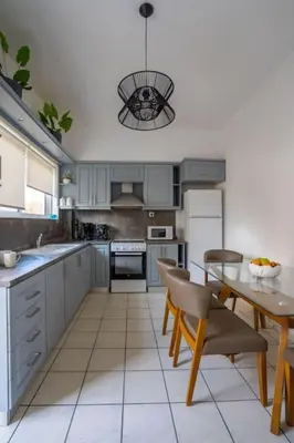 a large kitchen with a table and a dining room at Eden’s garden in Chania Town