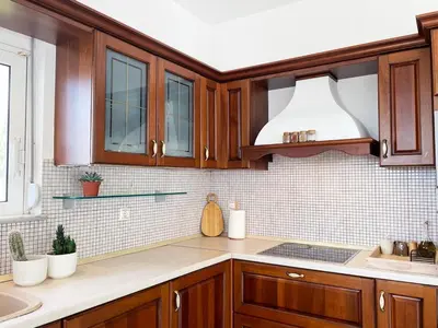 a kitchen with wooden cabinets and a sink at FLAT 45 in Kounoupidhianá