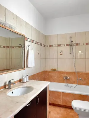 a bathroom with a sink and a tub and a shower at FLAT 45 in Kounoupidhianá