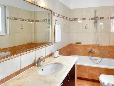 a bathroom with a sink and a shower and a tub at FLAT 45 in Kounoupidhianá