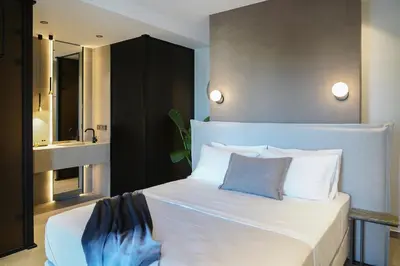 a bedroom with a large white bed and a sink at AGAVE HILL LUXURY HOUSE in Chania Town