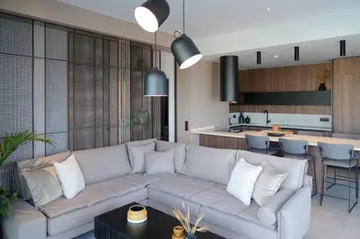 a living room with a couch and a kitchen at AGAVE HILL LUXURY HOUSE in Chania Town