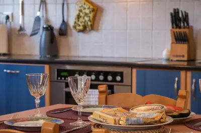a table with two wine glasses on it in a kitchen at Villa Festos in Voúvai