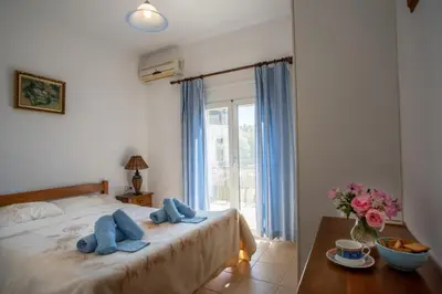 a bedroom with a bed with blue towels on it at Villa Festos in Voúvai