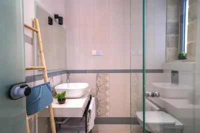 a bathroom with two sinks and a glass shower at Aiolos Executive Suite in Galatás
