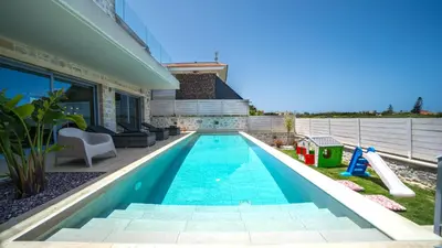a swimming pool in the backyard of a house at Aiolos Executive Suite in Galatás