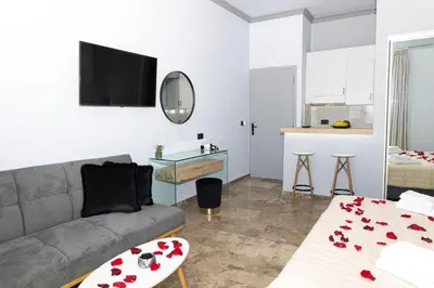 a living room with a couch and a table at Queen Mary Beachfront Studios in Agia Marina Nea Kydonias