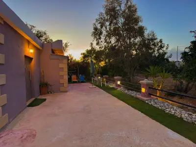 a driveway leading to a house with a tree at Beautiful Life Rooms with Sea View - Next to Elafonisi Beach in Elafonisi