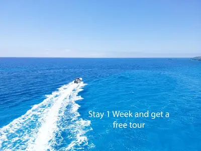 a boat in the middle of the ocean at Beautiful Life Rooms with Sea View - Next to Elafonisi Beach in Elafonisi