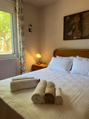 a bedroom with a bed with towels on it at The Twin Pines Home in Kounoupidhianá