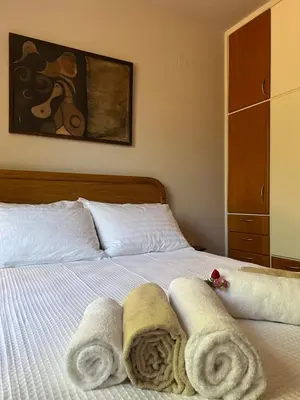 a bedroom with a bed with towels on it at The Twin Pines Home in Kounoupidhianá