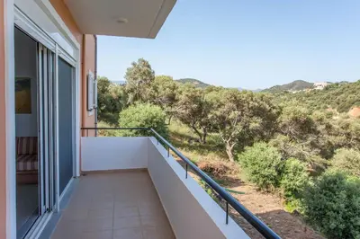 a balcony with a view of a mountain at Hillside Seaview Apartment in Stalos