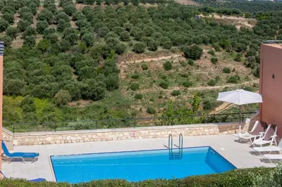 a view of a swimming pool from a house at Hillside Seaview Apartment in Stalos