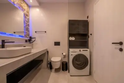 a bathroom with a sink and a washing machine at White House Boutique in Koukounará