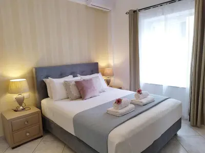 a bedroom with a large bed with towels on it at Virma Studio in Chania Town