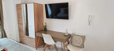 a room with a desk and a television on a wall at Virma Studio in Chania Town