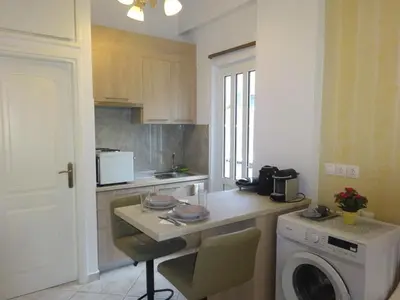 a kitchen with a washing machine and a washer at Virma Studio in Chania Town