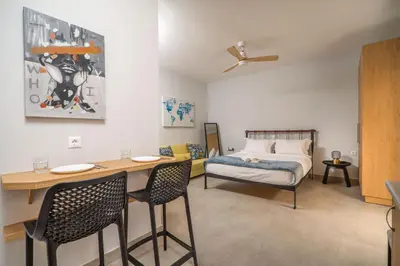 a bedroom with a bed and a table and chairs at Cozy Spot near the beach in Plataniás