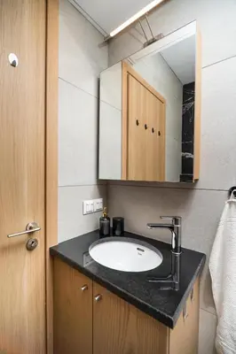 a bathroom with a sink and a mirror at Cozy Spot near the beach in Plataniás