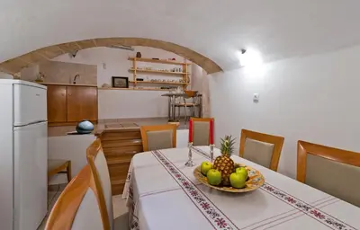 a kitchen and a table with a bowl of fruit on it at Odyssey House in Chania Town
