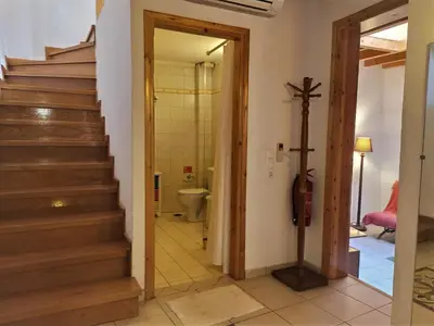 a hallway with stairs and a toilet in a house at Odyssey House in Chania Town