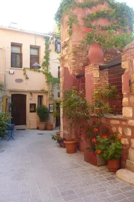 an alley with potted plants in front of a building at Odyssey House in Chania Town