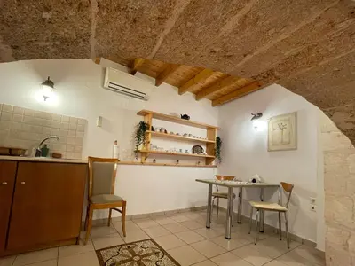 a kitchen and dining room with a table and chairs at Odyssey House in Chania Town