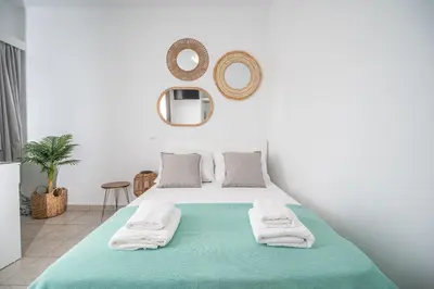 a white bedroom with a bed with towels on it at ''Meraviglia casa'' Christin in Kato Daratso
