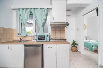 a kitchen with a sink and a microwave at ''Meraviglia casa'' Christin in Kato Daratso