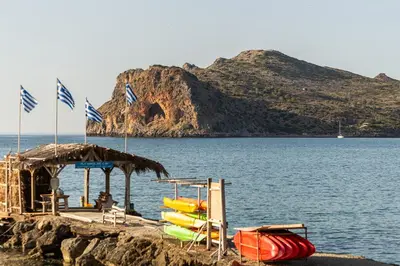 a group of boats on the shore of a body of water at Celeste Suite on the Beach in Agia Marina Nea Kydonias