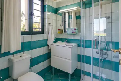 a bathroom with a toilet and a sink and a shower at Villa Anni by Villa Plus in Pírgos Psilonérou