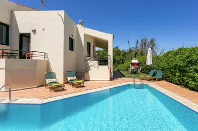 a villa with a swimming pool and a house at Villa Anni by Villa Plus in Pírgos Psilonérou