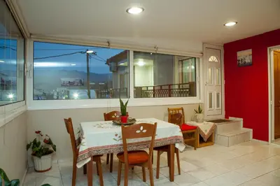 a dining room with a table and chairs and a window at Georgia's House Chania in Chania Town