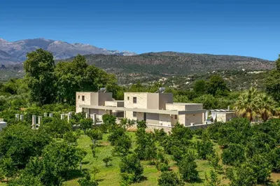 a house on top of a hill with trees at Villa Potami Nikos by Villa Plus in Stílos