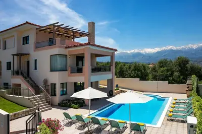 a villa with a swimming pool and a house at Villa Katerina Pente by Villa Plus in Kalyves