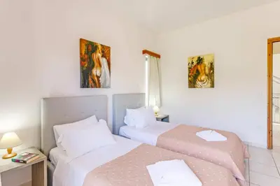 two beds in a hotel room with two at Villa Katerina Pente by Villa Plus in Kalyves