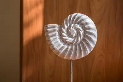 a shell on top of a wooden table at Luxury Coastal Retreat, Mountain View Balcony with Palm Trees & Parking in Chania Town