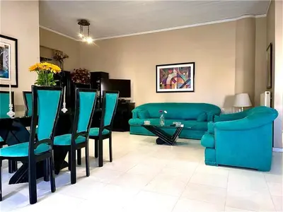 a living room with a couch and a table and chairs at Christina_Apt in Chania Town