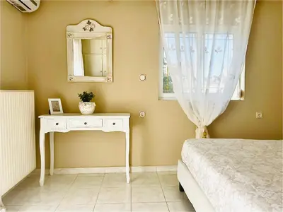 a bedroom with a bed and a mirror and a table at Christina_Apt in Chania Town