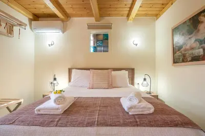 a bedroom with a bed with two towels on it at Avocado Villas in Chania Town
