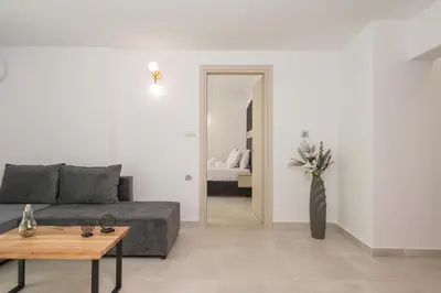 a living room with a couch and a table at Quarters Luxury Apts in Chania Town