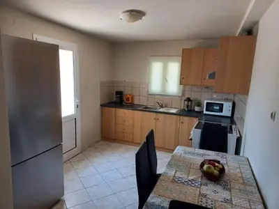 a kitchen with a table with a bowl of fruit on it at Casa Constans in Maleme