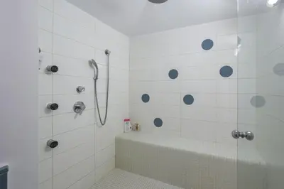 a white bathroom with a shower with a tub at Luxury Villas near The Sea With Heated Pool in Kato Daratso