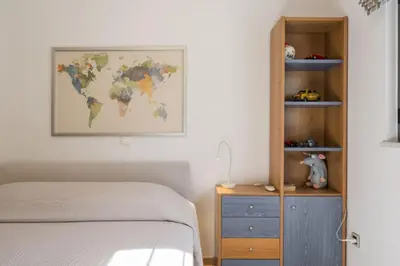 a bedroom with a bed and a world map on the wall at Luxury Villas near The Sea With Heated Pool in Kato Daratso